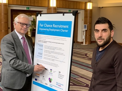 two people in front of charter agreement