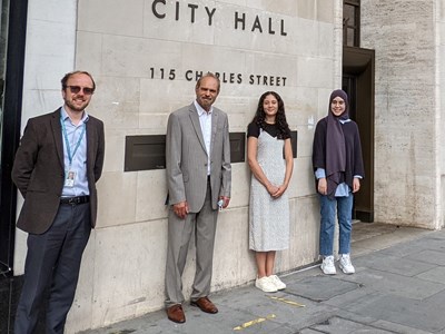 four people outside City Hall